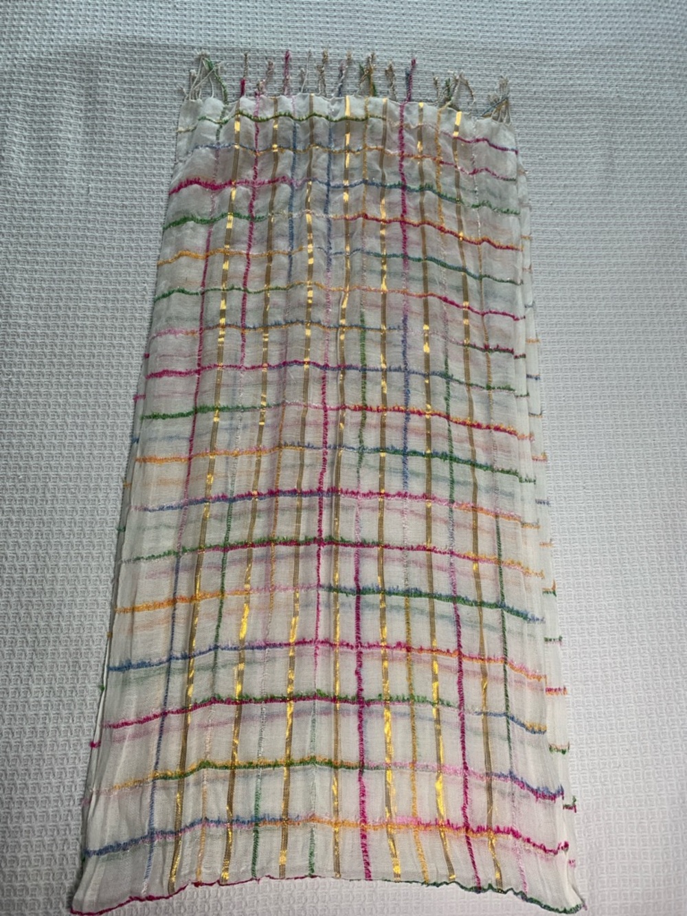 White, metallic gold, pink, blue, and green scarf with fringe
